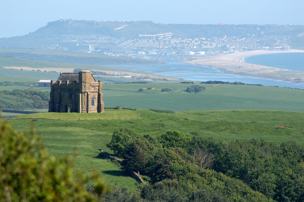 St Catherine's Chapel in Abbotsbury, with Chesil beach in the background. From Jurassic Coast